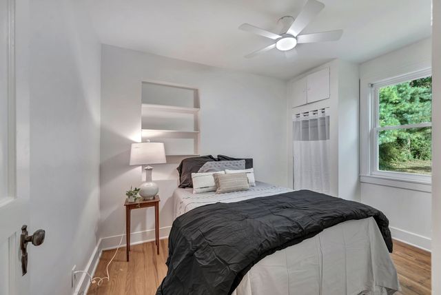 a bedroom with a bed and a window