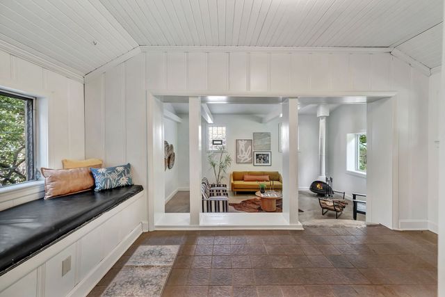 a lobby with furniture and floor to ceiling window