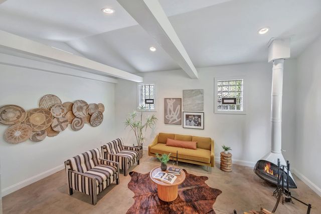 a living room with furniture and a chair