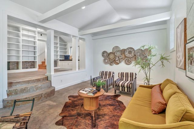 a living room with furniture and a potted plant
