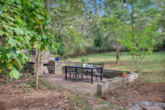 a view of a backyard with sitting area