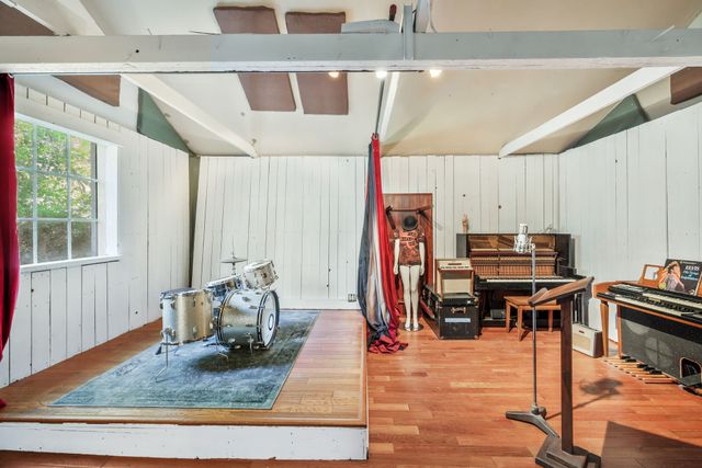 a living room filled with furniture and a piano