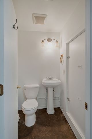 a white toilet sitting next to a white sink