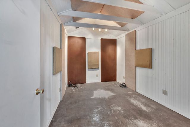 a view of a hallway with wooden shelves