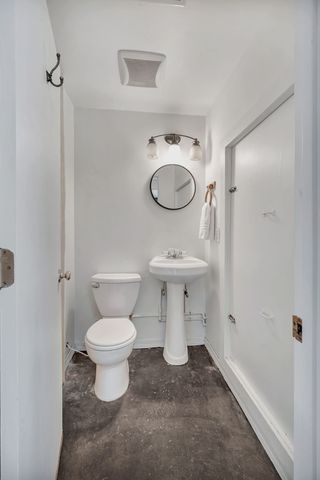 a white toilet sitting next to a bathroom sink