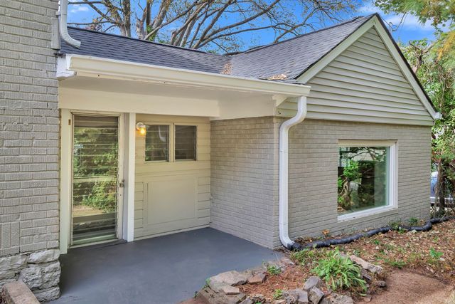 a view of a house with potted plants