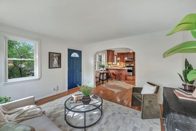 a living room with furniture and a potted plant