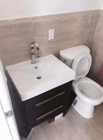 a kitchen with a sink and a refrigerator