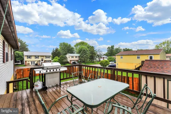 a view of a chairs and table on the roof deck