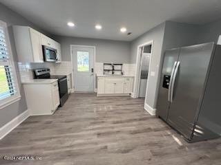 1355-1 Blackmon Road Green Cove Springs, FL 32043 - Photo 8 of 14 a kitchen with stainless steel appliances a refrigerator sink and stove top oven