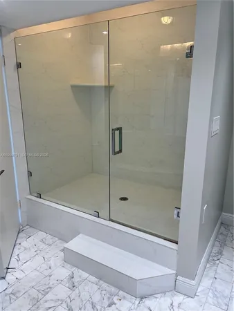 a bathroom with a double vanity sink mirror and shower