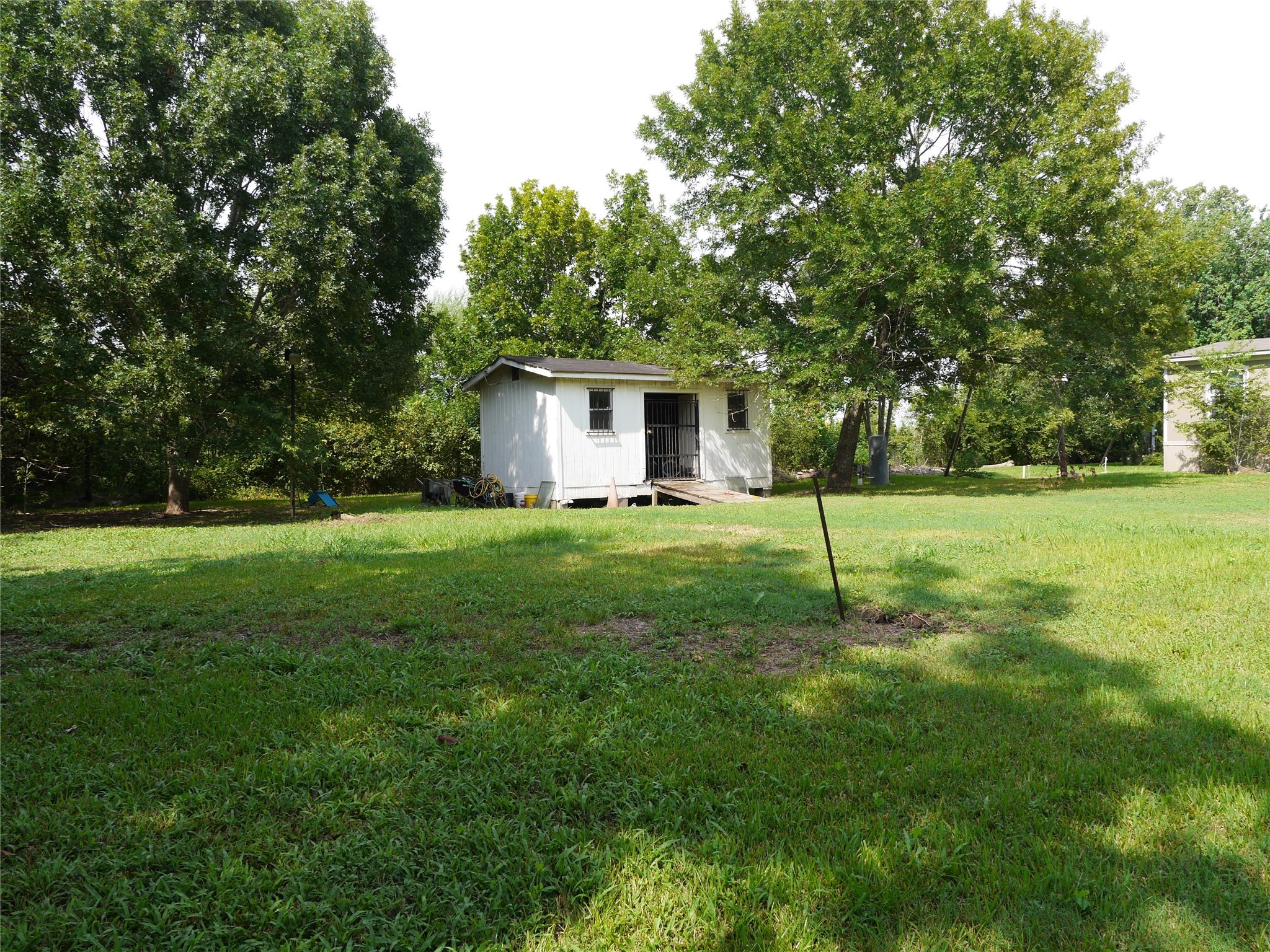 16020 1/2 Sam Brookins Street Sugar Land, TX 77498 - Photo 22 of 23 a backyard of a house with plants and large tree