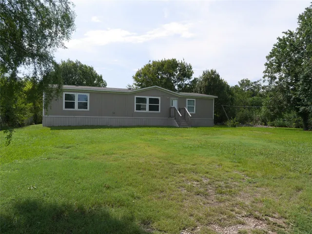 a view of house with backyard