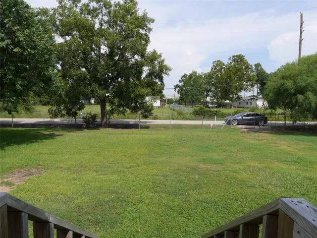 a view of a field of grass and trees