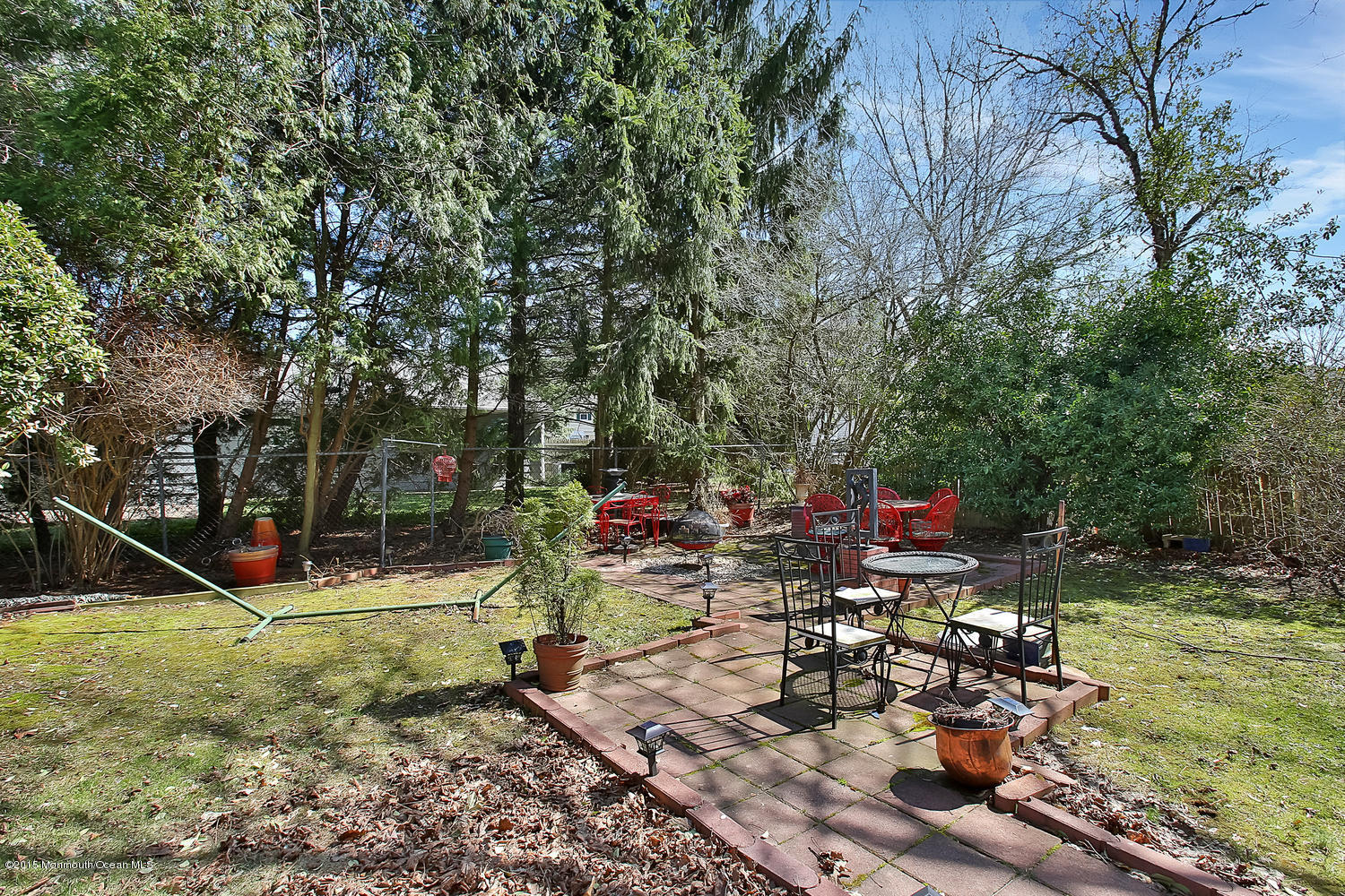 704 Schoolhouse Road Brielle, NJ 08730 - Photo 18 of 20 a view of a wooden chairs and fire pit in the yard