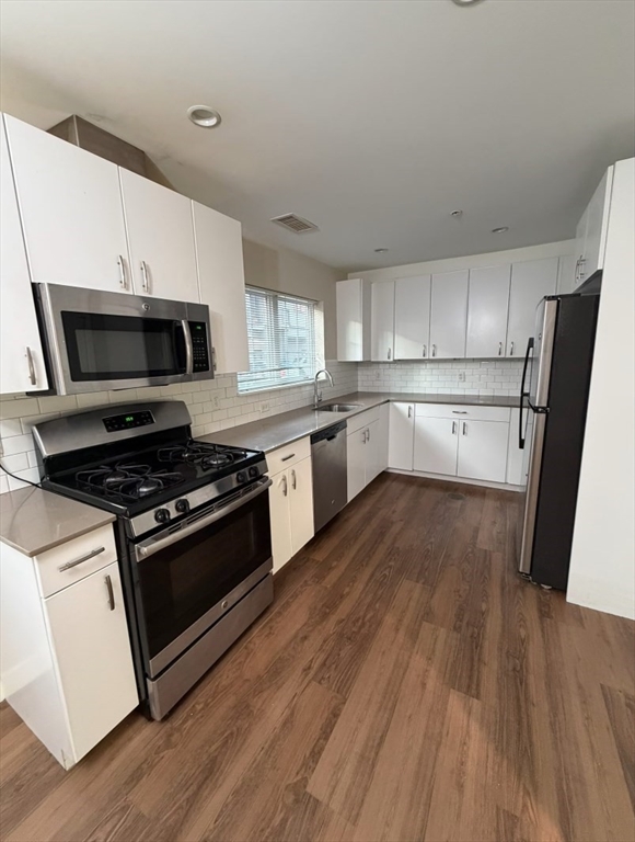 10 Myrtle Street, Unit 51B Waltham, MA 02453 - Photo 2 of 11 a kitchen with wooden floors and appliances
