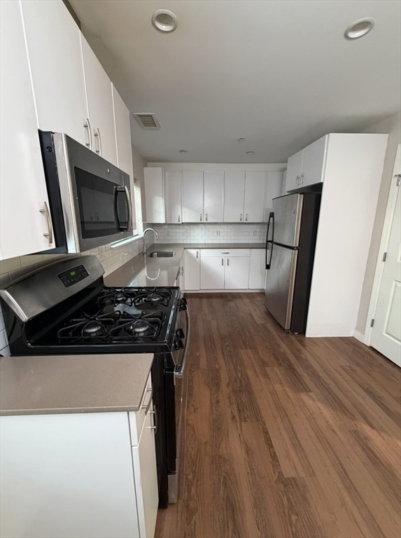 10 Myrtle Street, Unit 51B Waltham, MA 02453 - Photo 3 of 11 a kitchen with wooden floors and appliances
