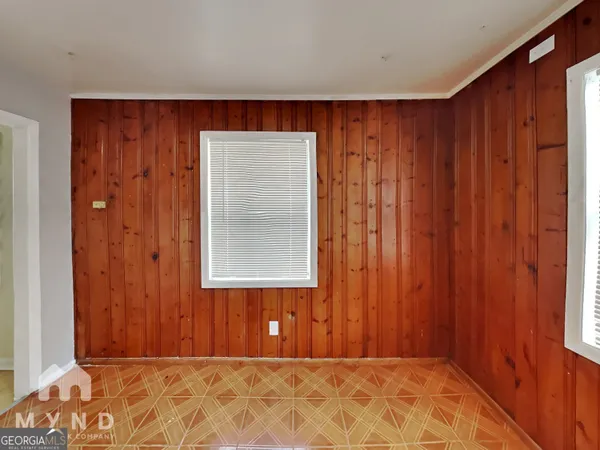 a view of a room with a wooden door