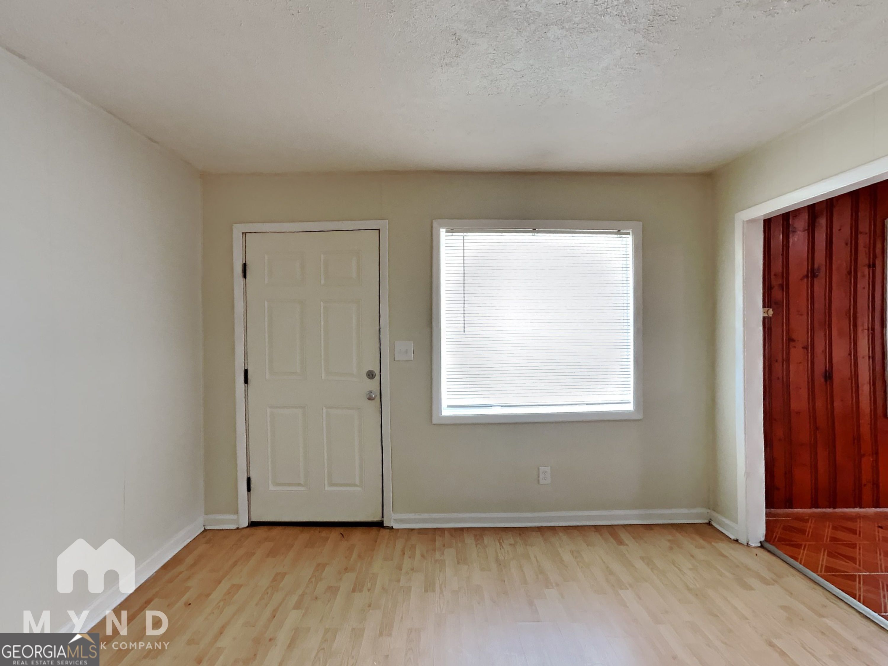 730 Hill Street Forest Park, GA 30297 - Photo 5 of 12 an empty room with wooden floor and windows