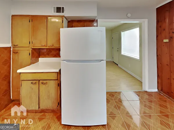 a white refrigerator freezer sitting in a kitchen