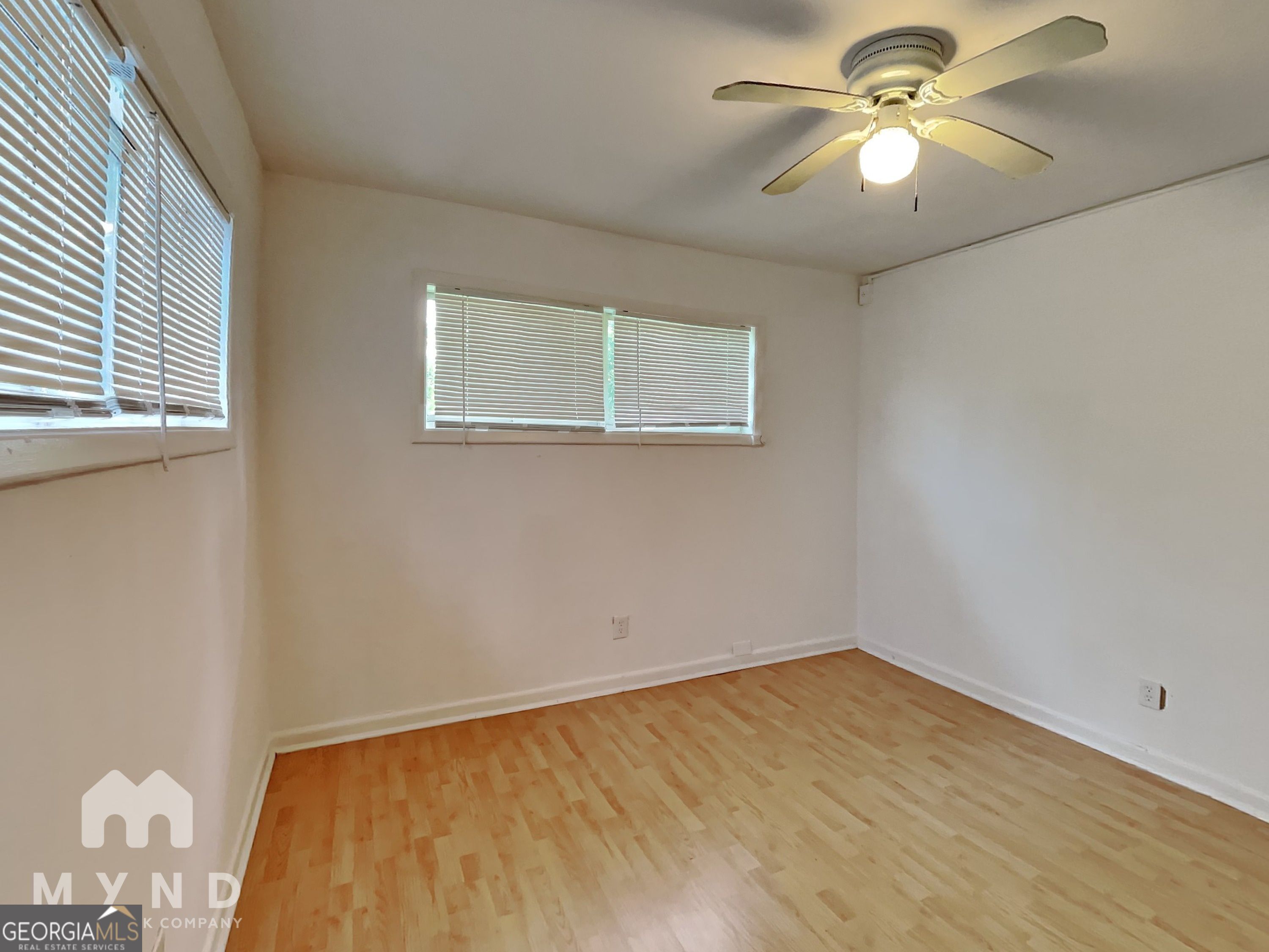 730 Hill Street Forest Park, GA 30297 - Photo 8 of 12 a view of empty room with wooden floor and fan