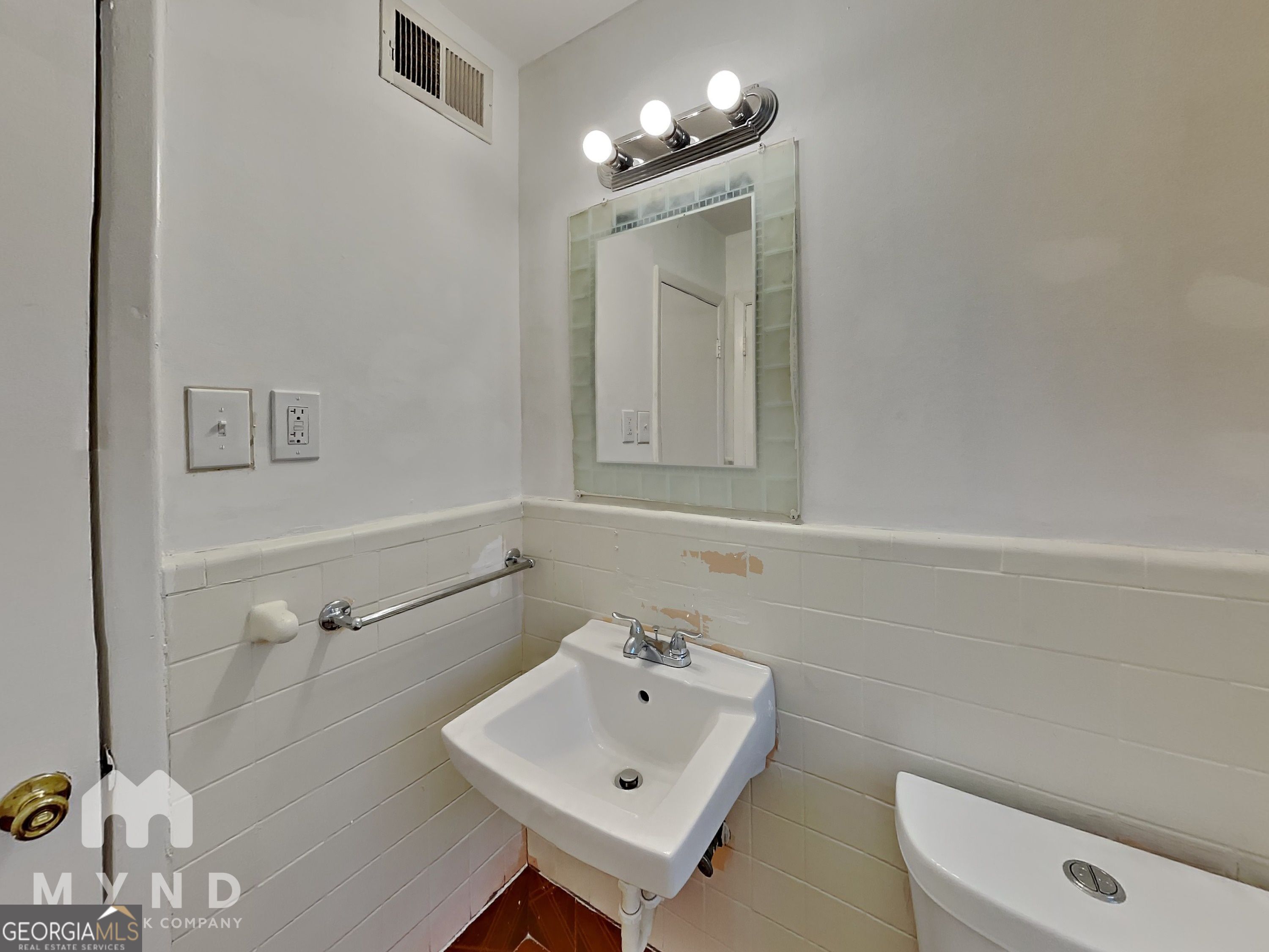 730 Hill Street Forest Park, GA 30297 - Photo 9 of 12 a bathroom with a toilet sink and mirror
