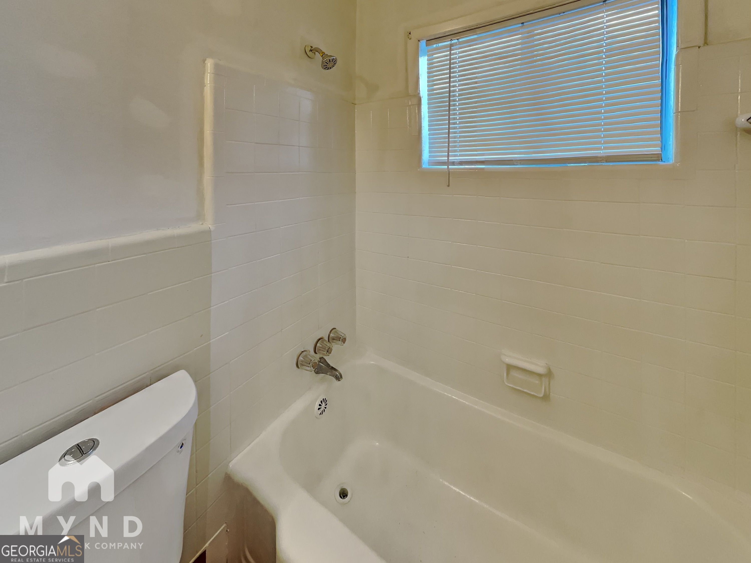 730 Hill Street Forest Park, GA 30297 - Photo 10 of 12 a bathroom with a bathtub and a shower