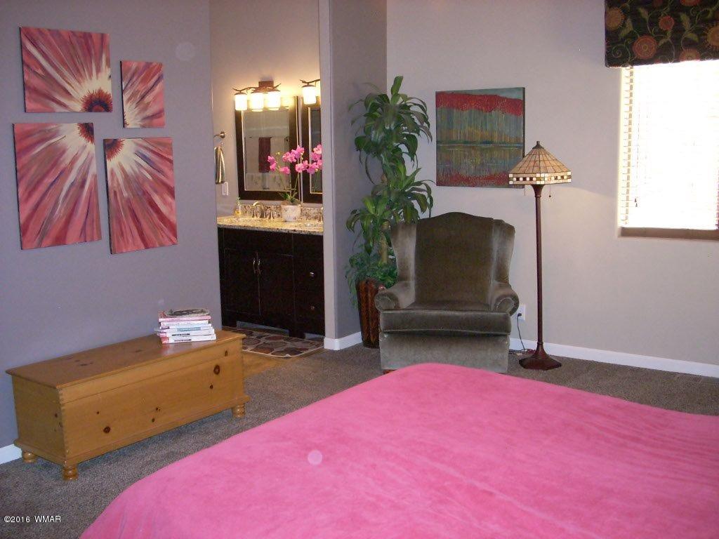 2975 East Lookout Lane Overgaard, AZ 85933 - Photo 12 of 34 a bedroom with a bed and a couch