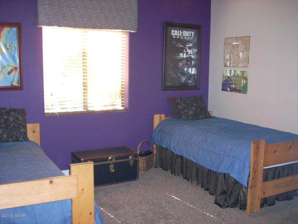 2975 East Lookout Lane Overgaard, AZ 85933 - Photo 15 of 34 a bedroom with a bed and a window