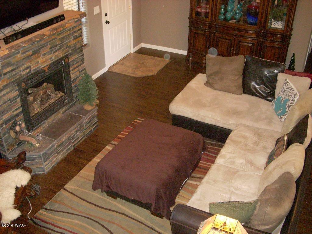 2975 East Lookout Lane Overgaard, AZ 85933 - Photo 22 of 34 a living room with furniture and a fireplace