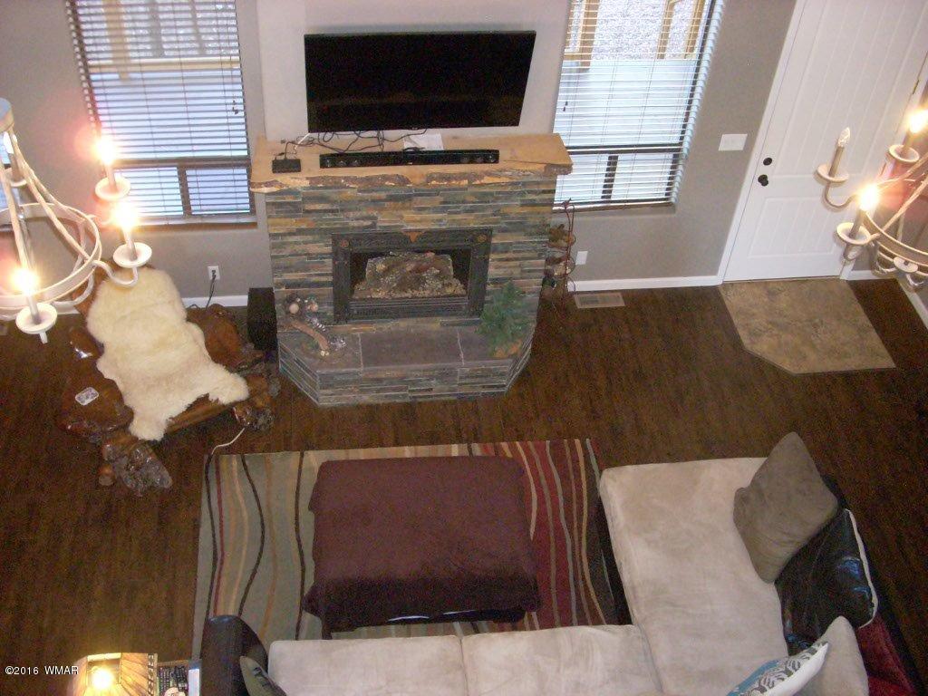 2975 East Lookout Lane Overgaard, AZ 85933 - Photo 26 of 34 a living room with furniture and a flat screen tv