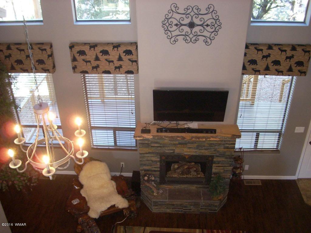 2975 East Lookout Lane Overgaard, AZ 85933 - Photo 27 of 34 a living room with furniture and a flat screen tv