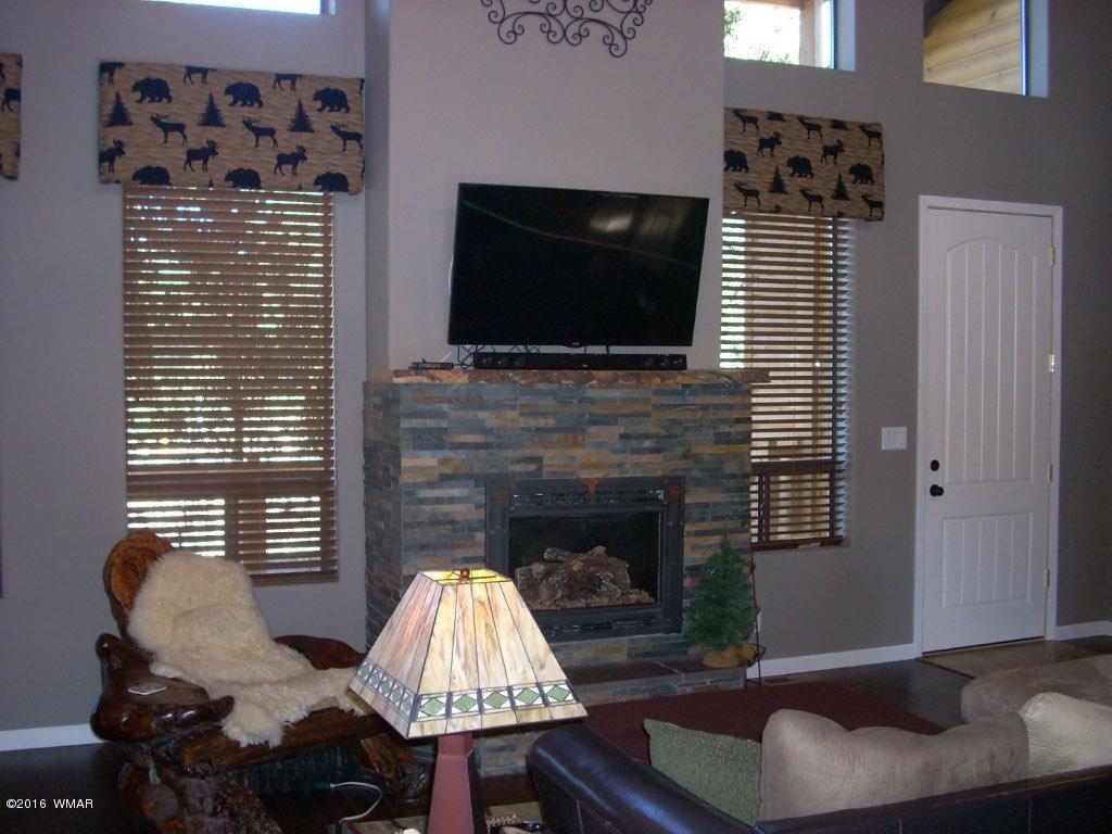 2975 East Lookout Lane Overgaard, AZ 85933 - Photo 4 of 34 a living room with furniture and a flat screen tv