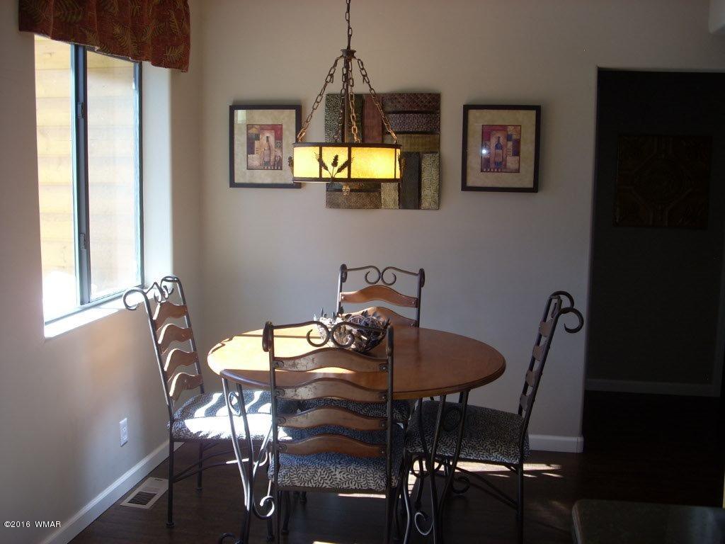 2975 East Lookout Lane Overgaard, AZ 85933 - Photo 9 of 34 a dining room with furniture and window