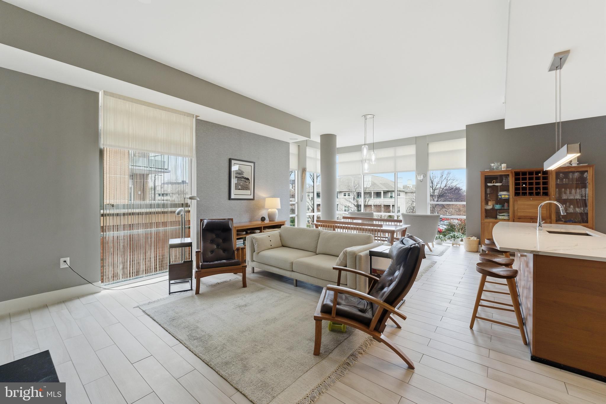 12025 New Dominion Parkway, Unit 103 Reston, VA 20190 - Photo 11 of 47 a living room with furniture and a table