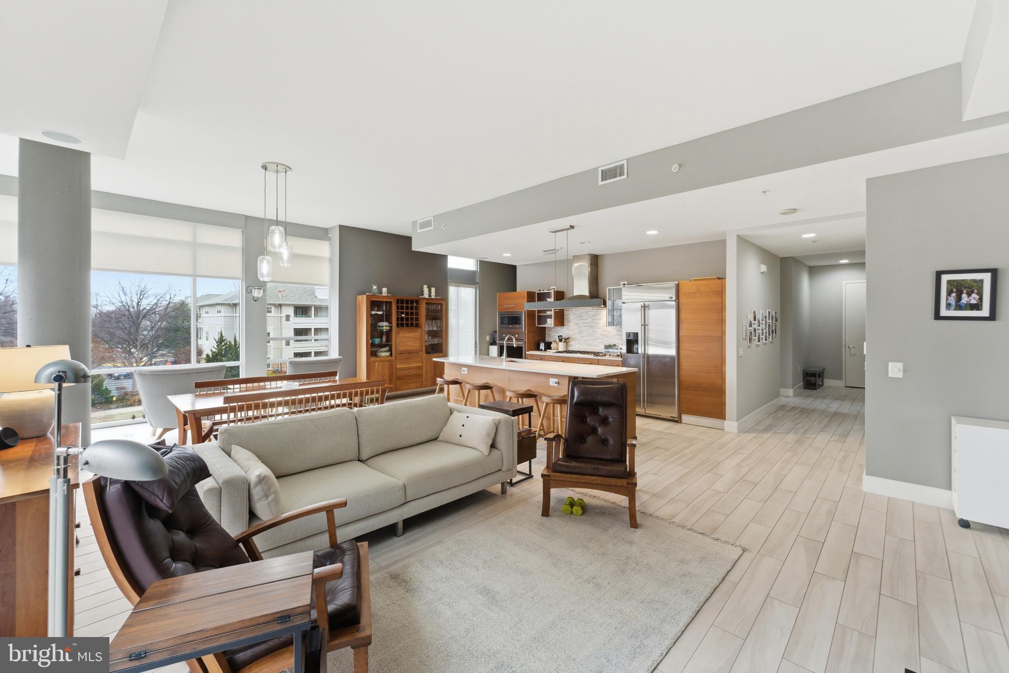 12025 New Dominion Parkway, Unit 103 Reston, VA 20190 - Photo 12 of 47 a living room with furniture and a large window