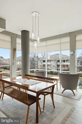 a roof deck with table and chairs