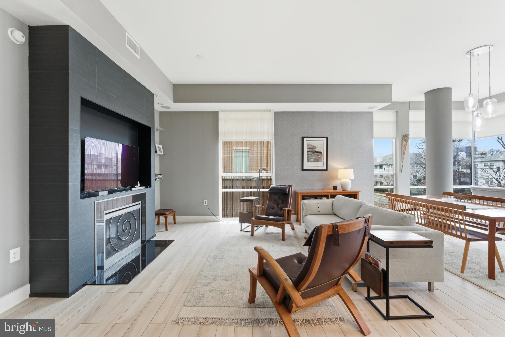 12025 New Dominion Parkway, Unit 103 Reston, VA 20190 - Photo 15 of 47 a living room with fireplace furniture and a flat screen tv