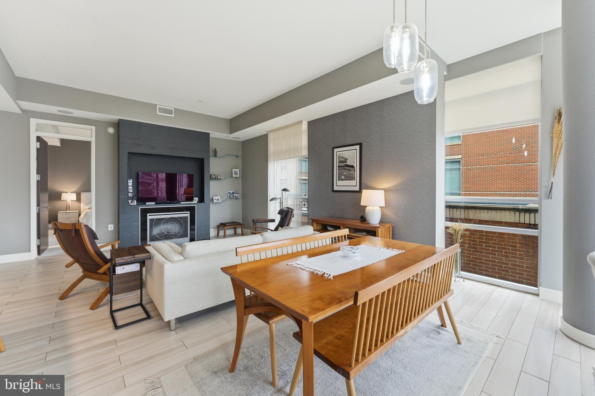 12025 New Dominion Parkway, Unit 103 Reston, VA 20190 - Photo 16 of 47 a dining room with a table chairs and a kitchen view