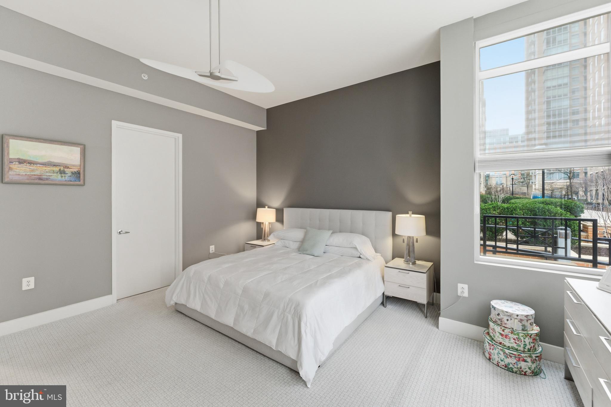 12025 New Dominion Parkway, Unit 103 Reston, VA 20190 - Photo 24 of 47 a bedroom with a bed lamp and window