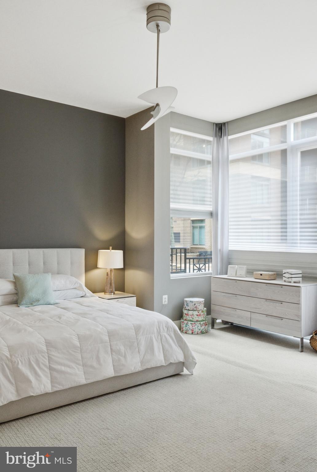 12025 New Dominion Parkway, Unit 103 Reston, VA 20190 - Photo 27 of 47 a bedroom with a bed and a large window