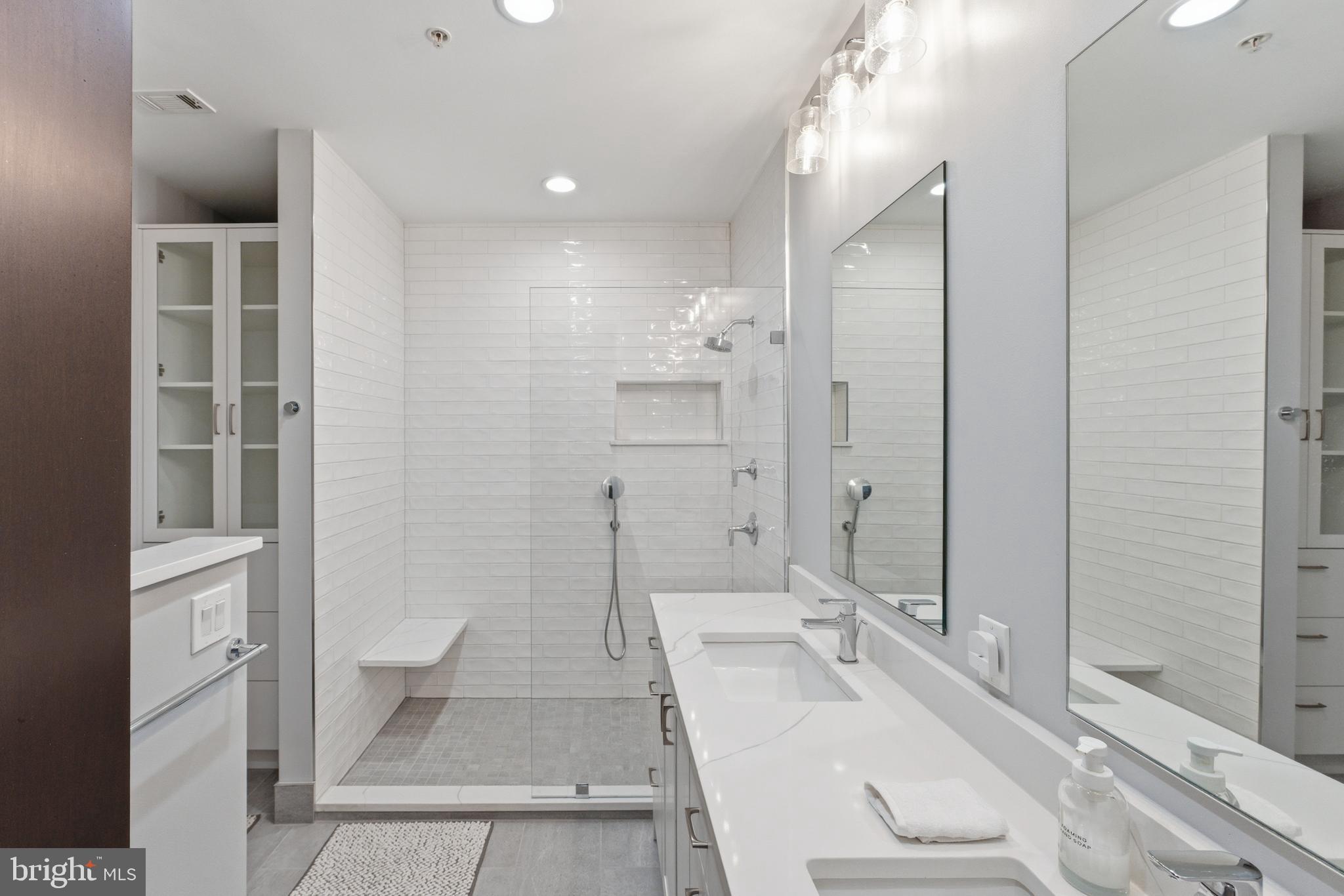 12025 New Dominion Parkway, Unit 103 Reston, VA 20190 - Photo 29 of 47 a bathroom with a sink a toilet and shower