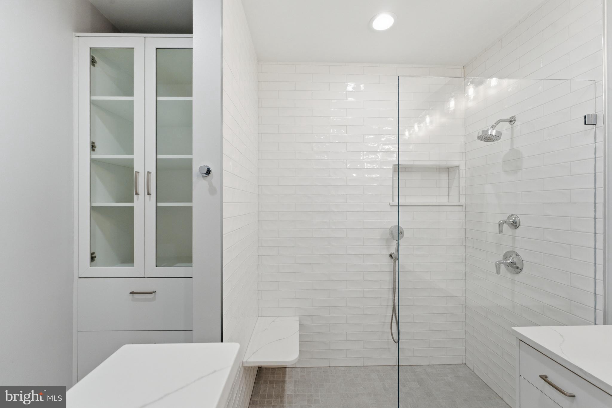 12025 New Dominion Parkway, Unit 103 Reston, VA 20190 - Photo 30 of 47 a bathroom with a shower and toilet