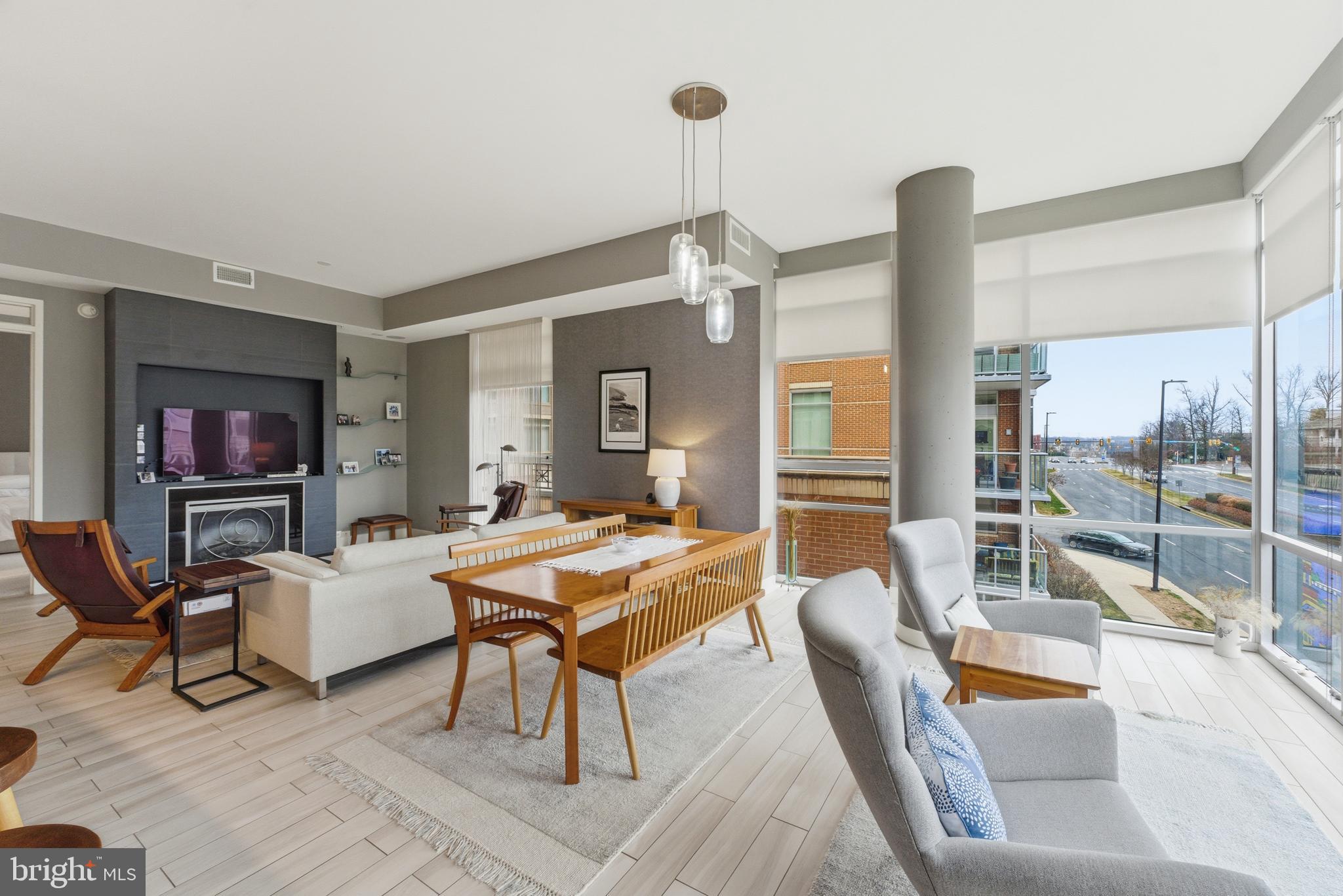 12025 New Dominion Parkway, Unit 103 Reston, VA 20190 - Photo 3 of 47 a living room with furniture and a flat screen tv