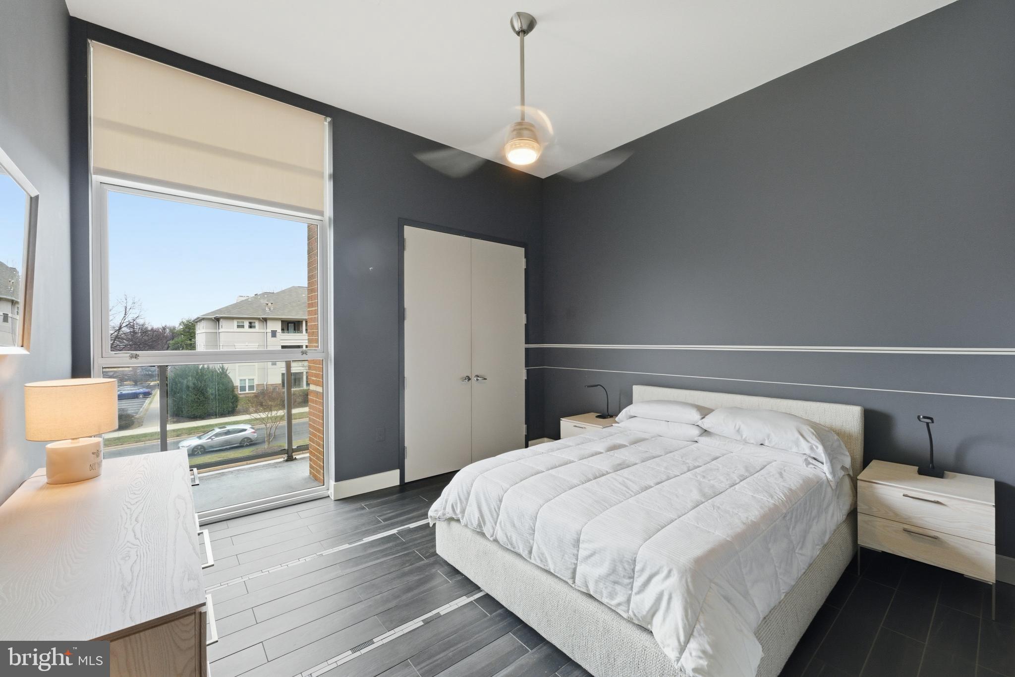 12025 New Dominion Parkway, Unit 103 Reston, VA 20190 - Photo 32 of 47 a bedroom with a large bed and a view of bedroom