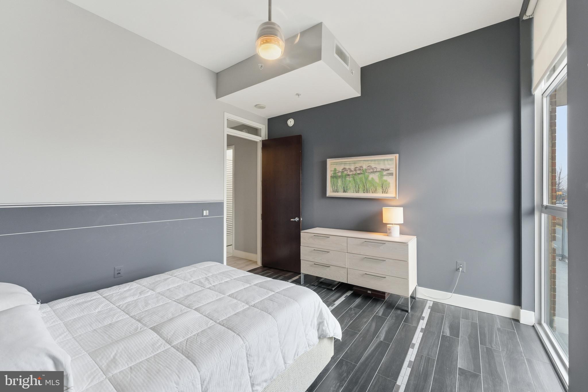 12025 New Dominion Parkway, Unit 103 Reston, VA 20190 - Photo 33 of 47 a bedroom with a bed and a window