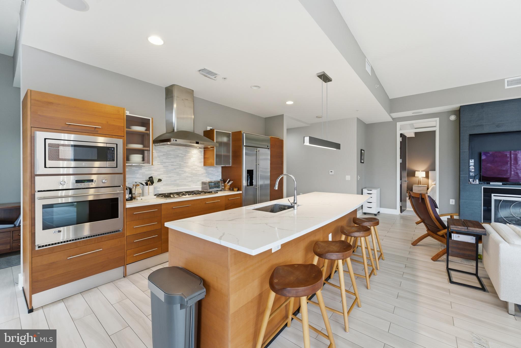 12025 New Dominion Parkway, Unit 103 Reston, VA 20190 - Photo 5 of 47 a large kitchen with a table and chairs