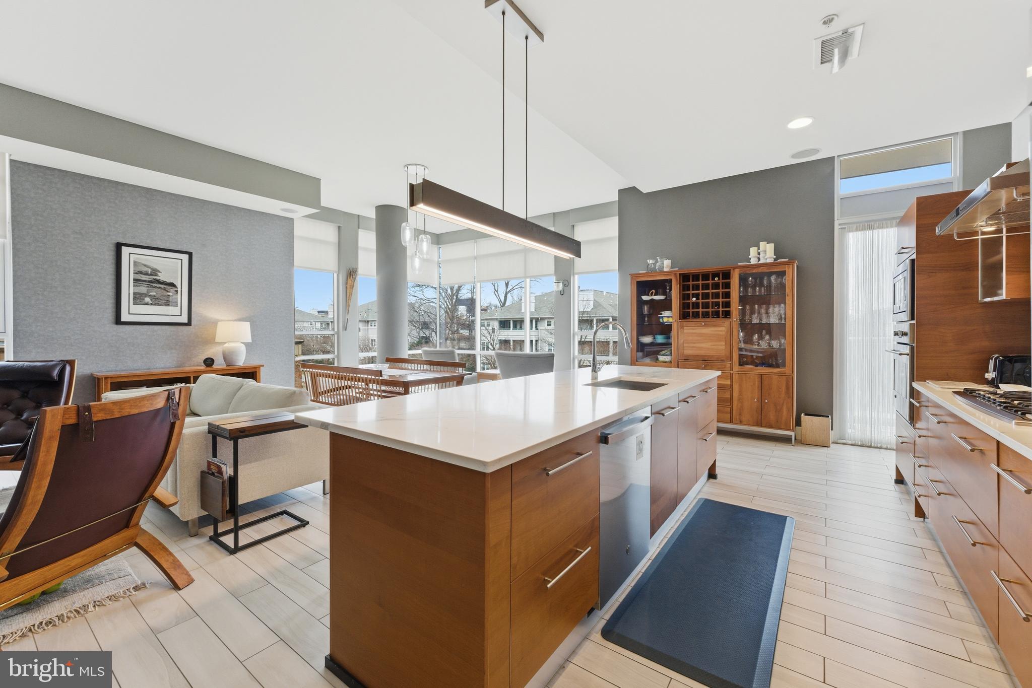 12025 New Dominion Parkway, Unit 103 Reston, VA 20190 - Photo 10 of 47 a large white kitchen with a large window and stainless steel appliances