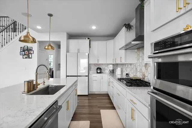 a kitchen with a sink a stove and cabinets