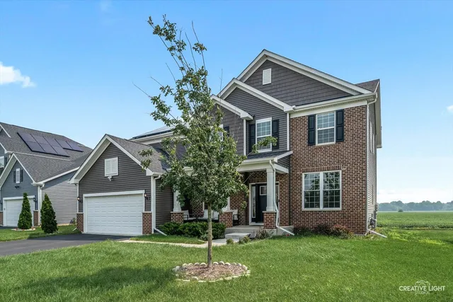 a front view of house with a garden